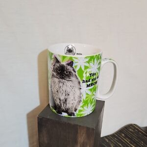 Playful Cat Mug with Green Leaf Design